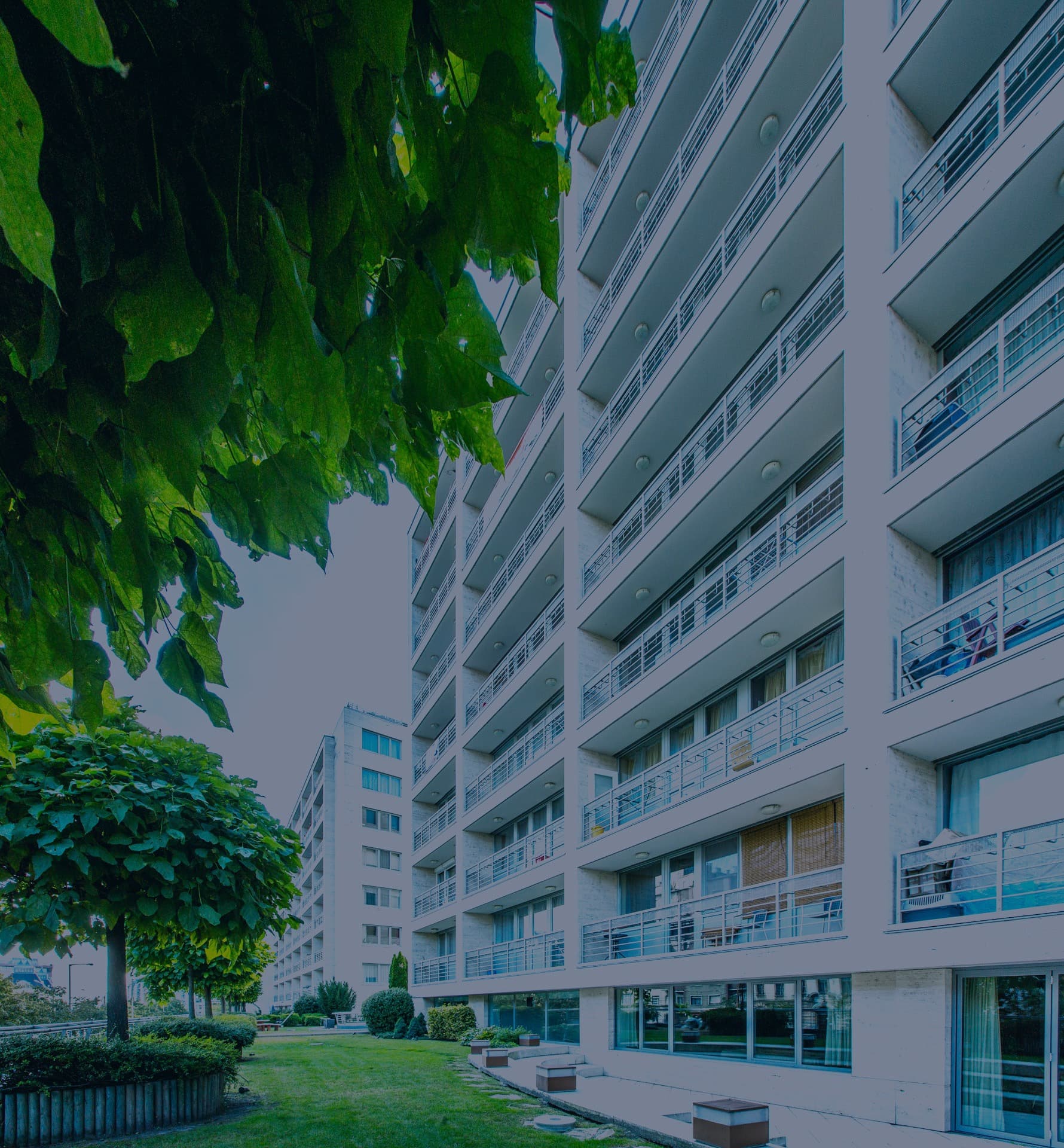 A residential building among trees.