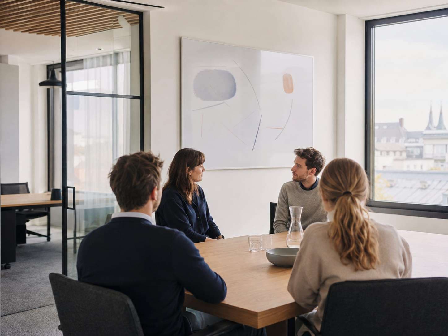Colleagues working together in a bright meeting room.